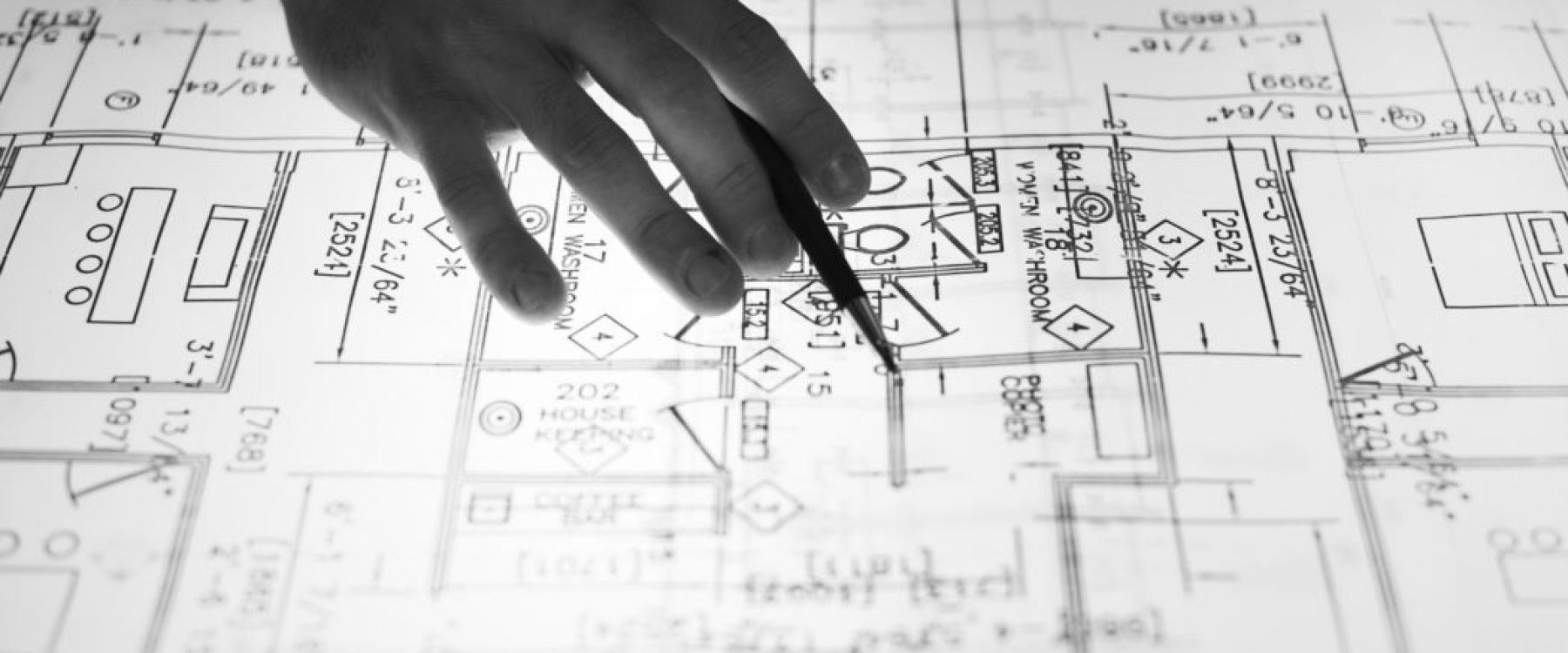 toronto commercial contractor advising a client on changes to architectural plans