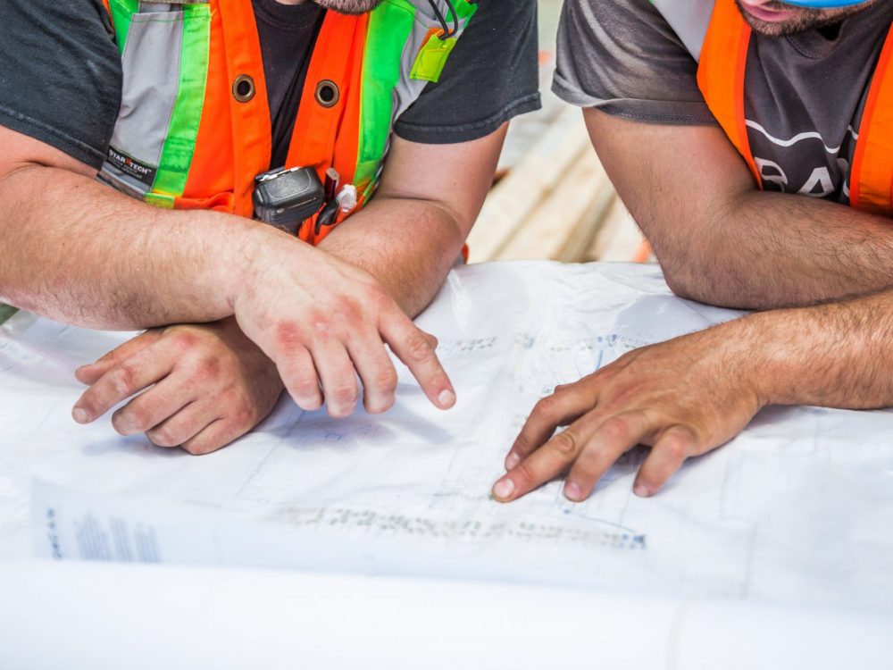 Prime Contractors reviewing plans on a commercial construction project in Canada