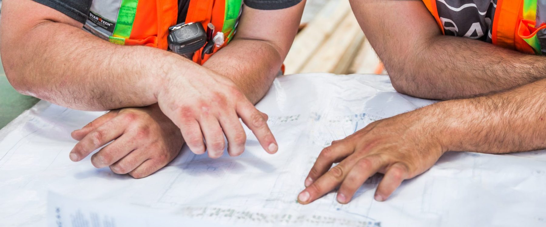 Prime Contractors reviewing plans on a commercial construction project in Canada
