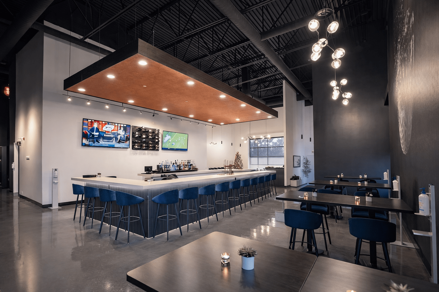 Indoor golf simulator room construction in Toronto featuring projection screen, acoustic wall panels, hitting platform, and custom entertainment build-out