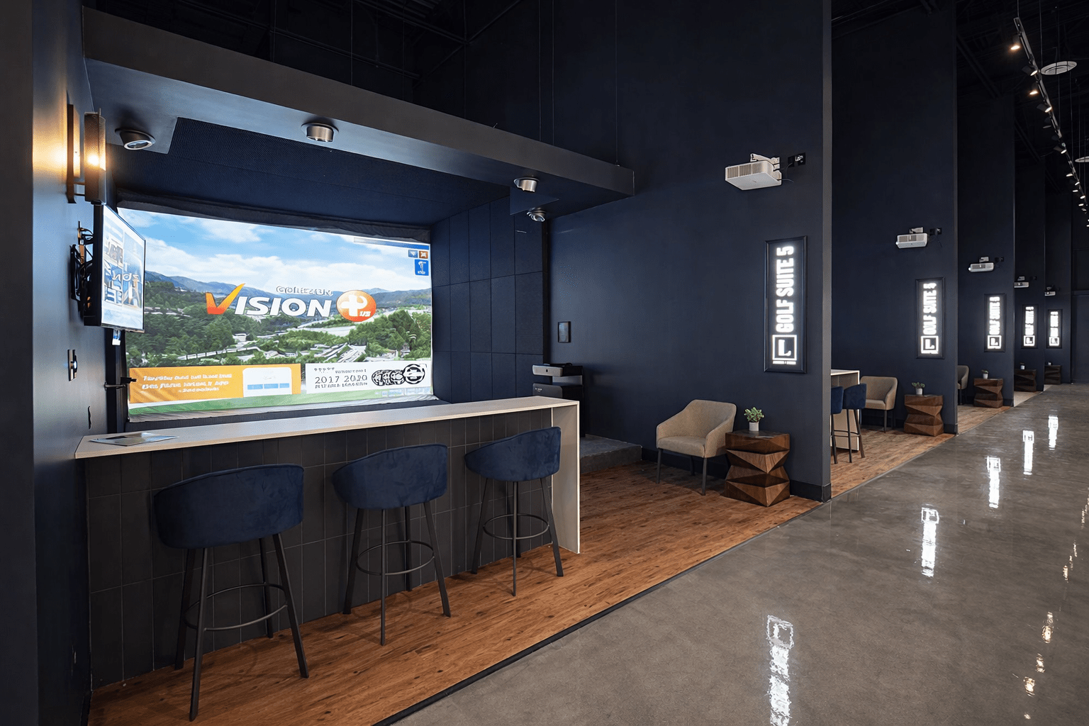 Golf simulator bays construction with private seating areas, wood flooring, signage, and entertainment build-out in Toronto recreational facility