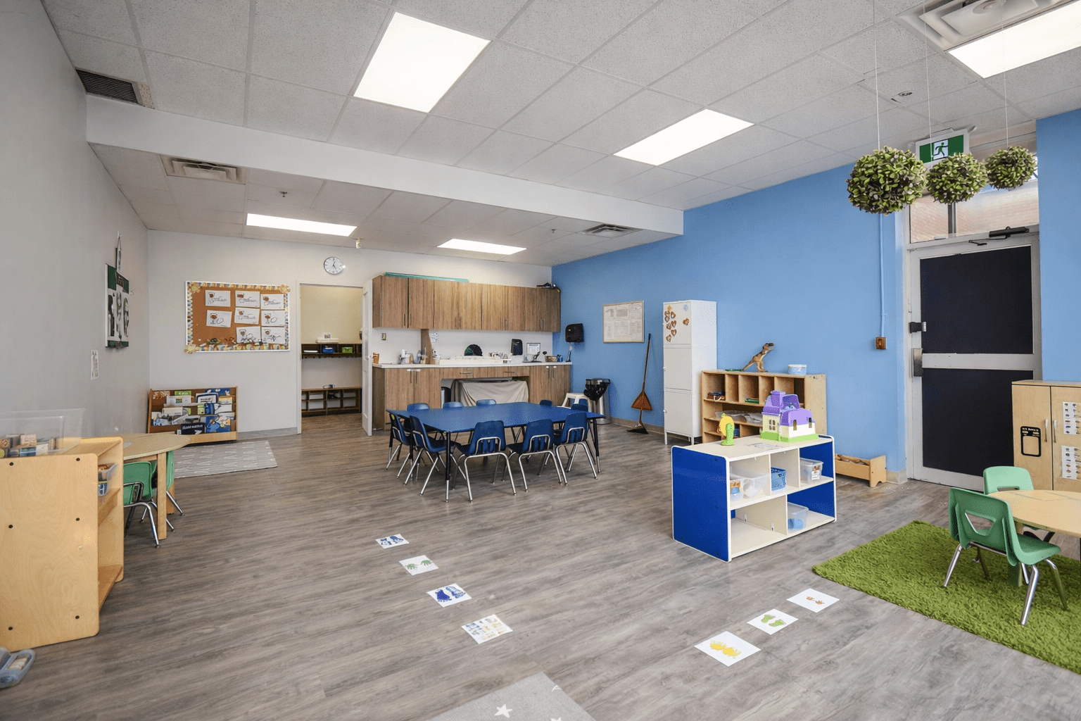 Preschool classroom with educational millwork storage, flexible seating layout, resilient flooring, and bright learning environment designed for early childhood development