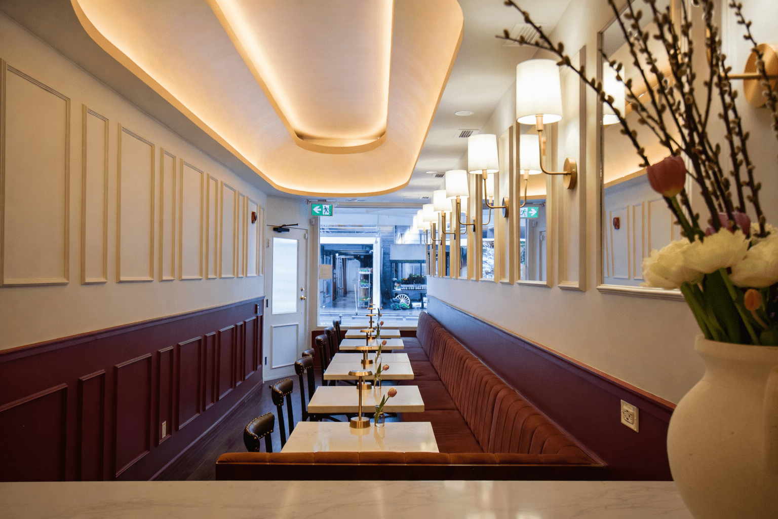 High-end restaurant interior construction in Toronto featuring custom millwork, wine display walls, premium lighting, and modern hospitality design by GTA General Contractors