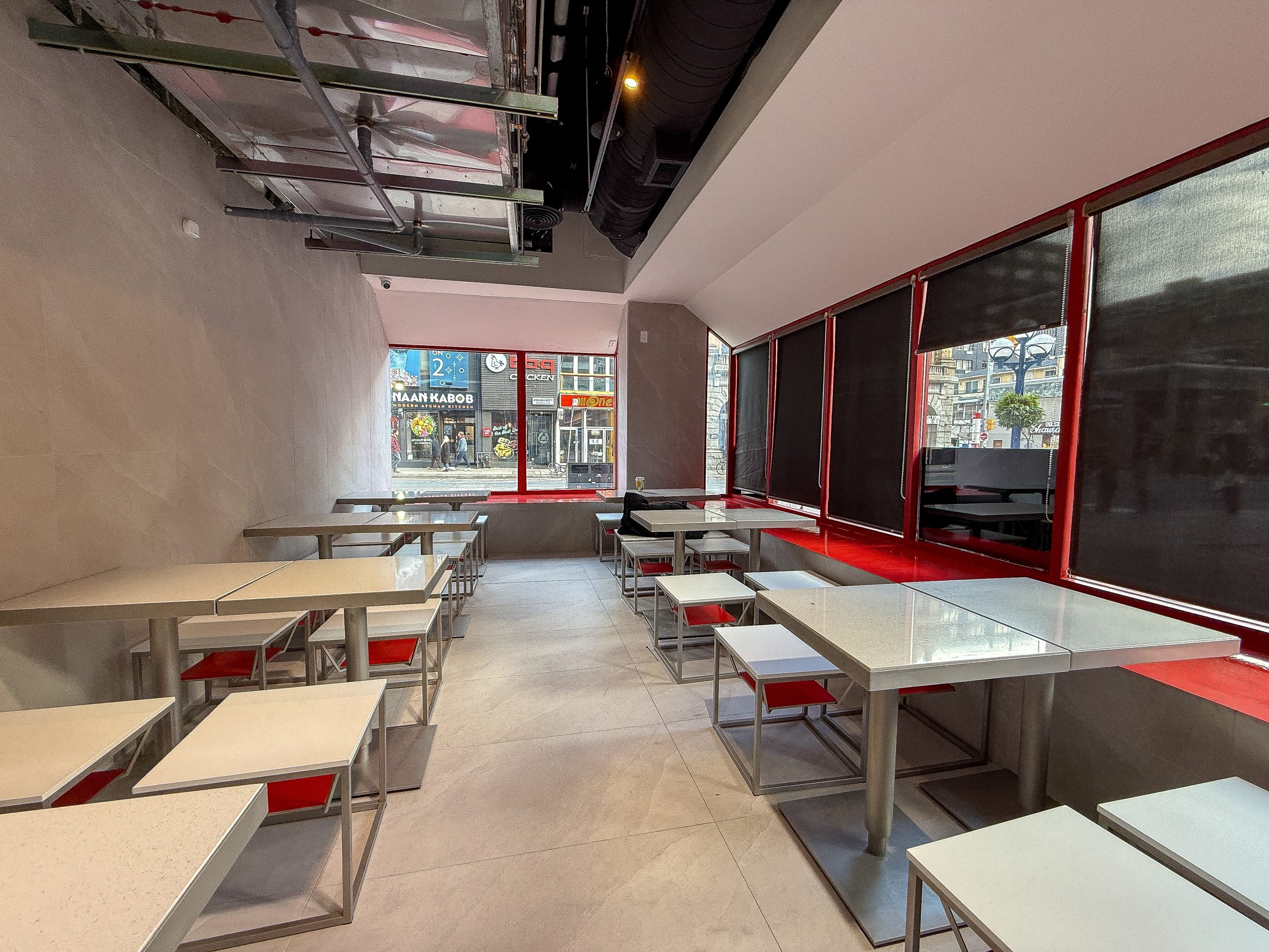 Modern fast-casual restaurant construction with durable flooring, open seating plan, and industrial-style exposed ductwork