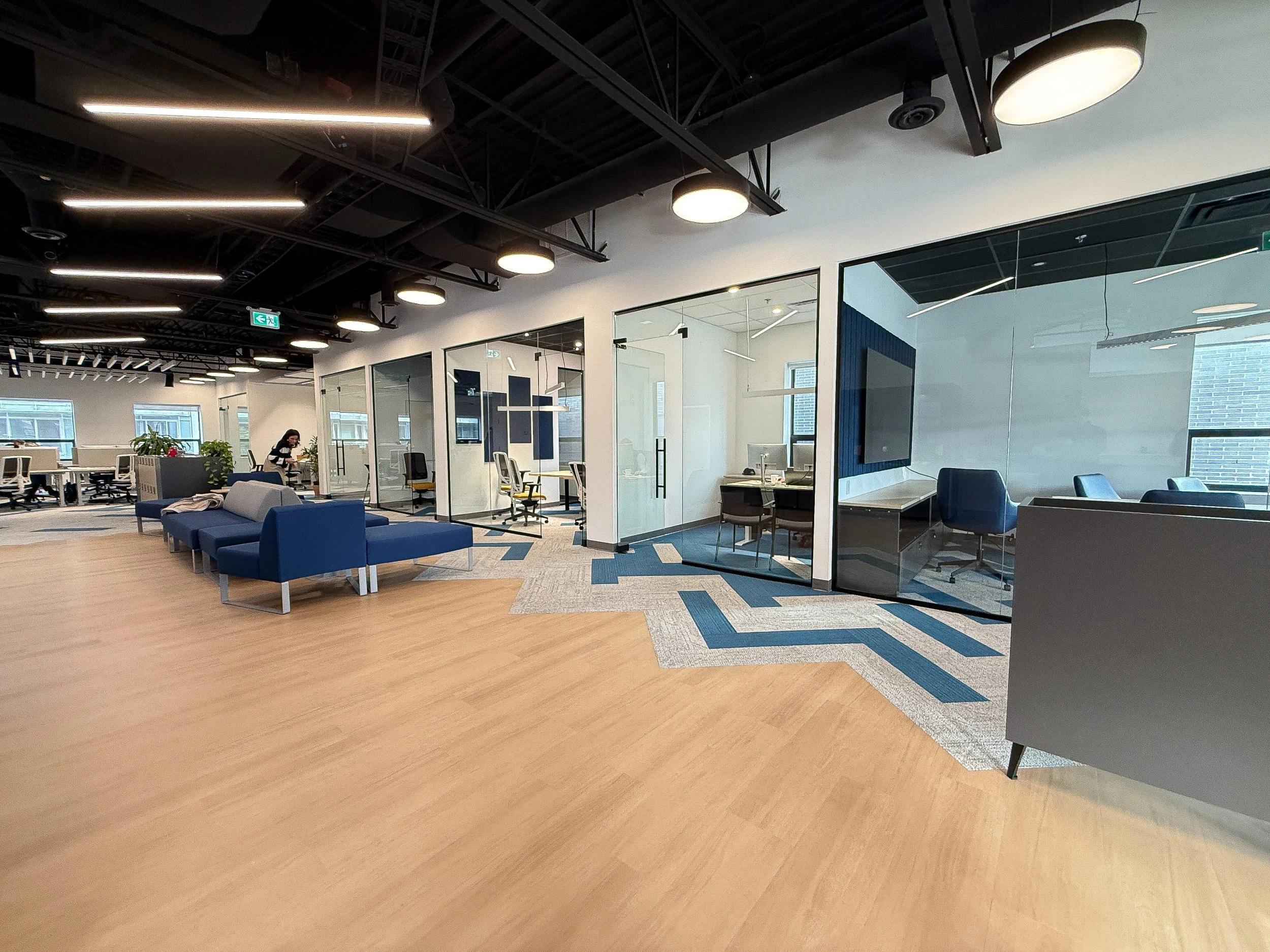 Newly completed Neoen Toronto office construction project featuring open-concept workstations and modern commercial interior design.