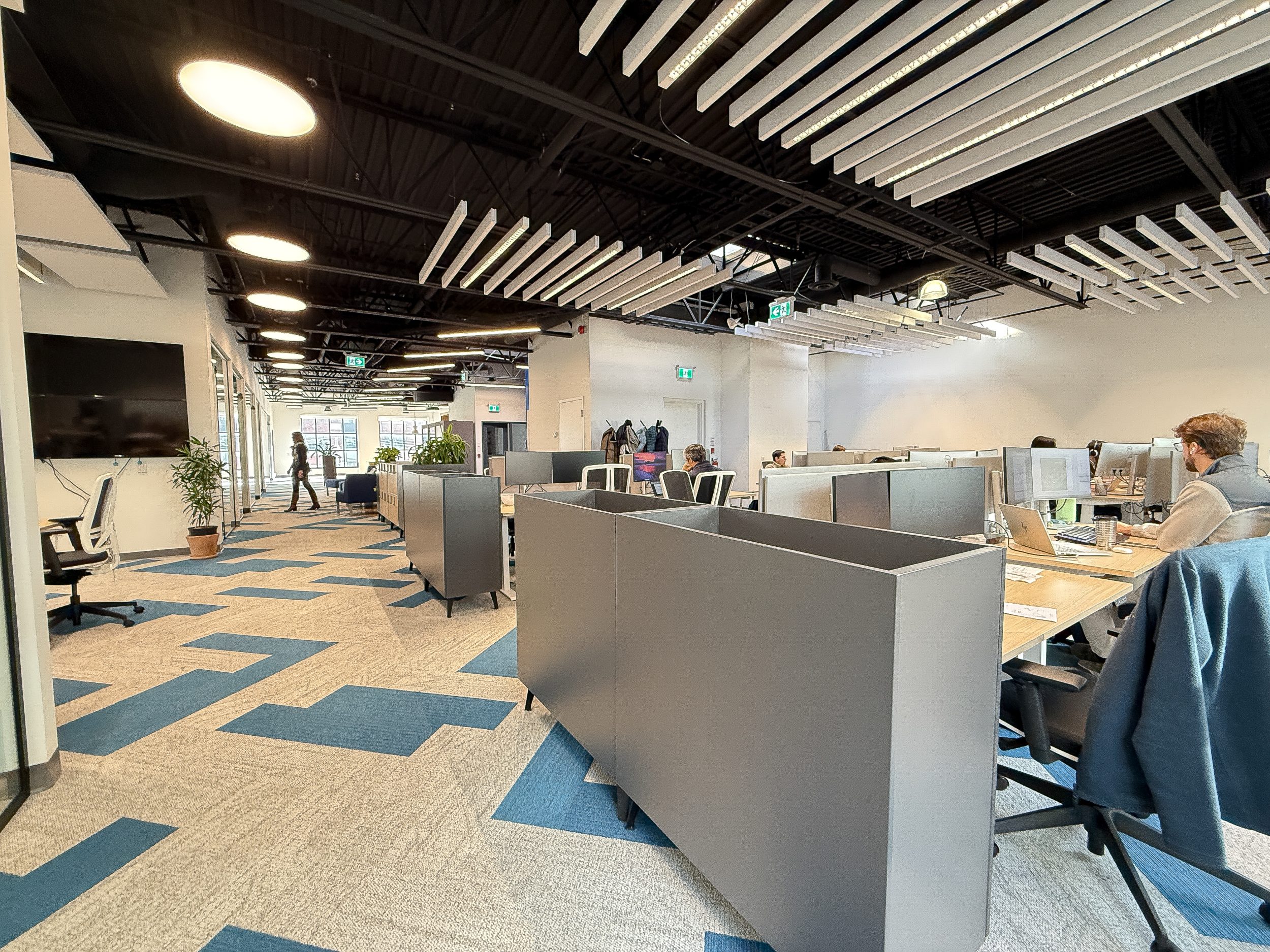 Corporate office construction project for Neoen with modern kitchen lounge area, wood millwork, and design-build office finishes