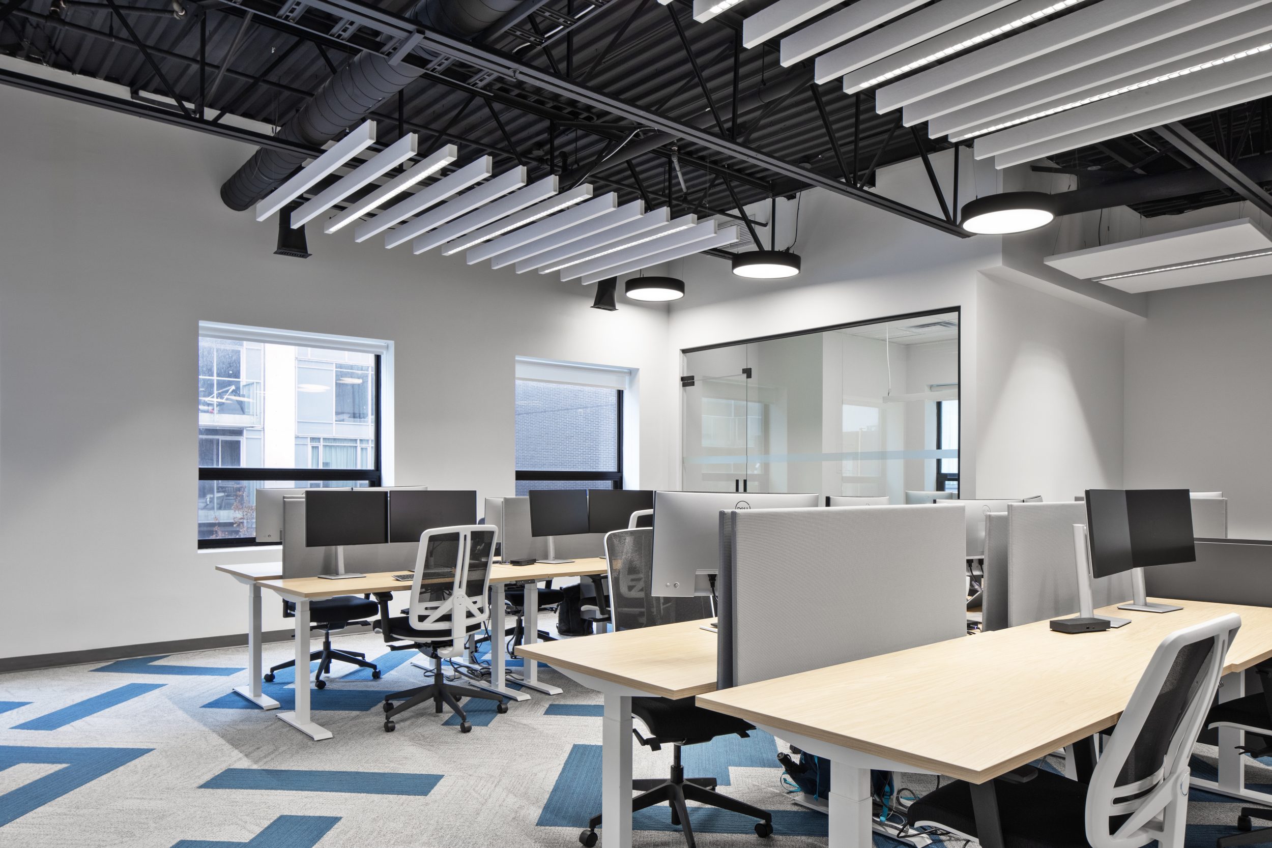 Neoen office build-out Toronto featuring open workstation layout, ergonomic desks, modern lighting, and corporate office design