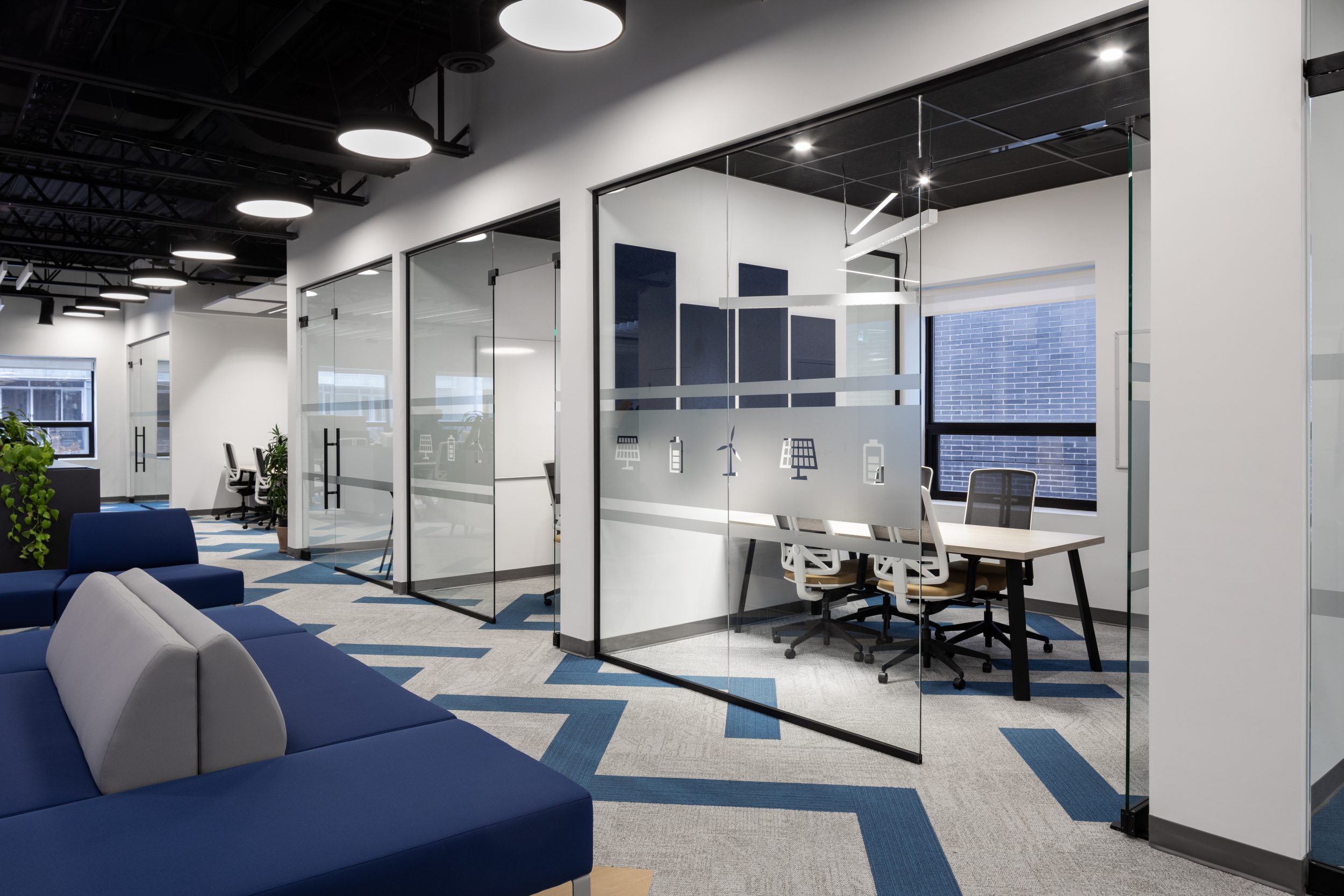 Neoen office construction Toronto featuring glass office partitions, modern meeting rooms, and open workspace design
