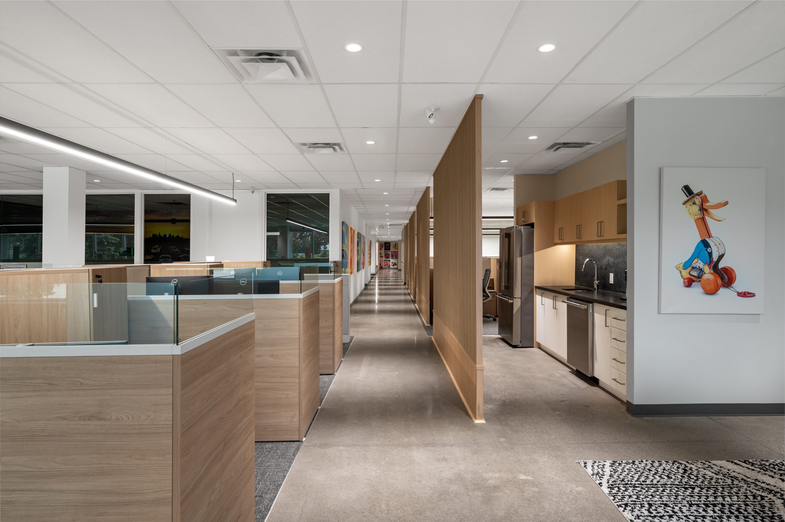 Executive office at Mattel Canada Headquarters in Mississauga, Ontario, featuring a custom meeting table, executive workstation, ergonomic seating, integrated audiovisual technology, natural daylight, premium commercial office furniture, and a Design-Build office renovation completed by GTA General Contractors.