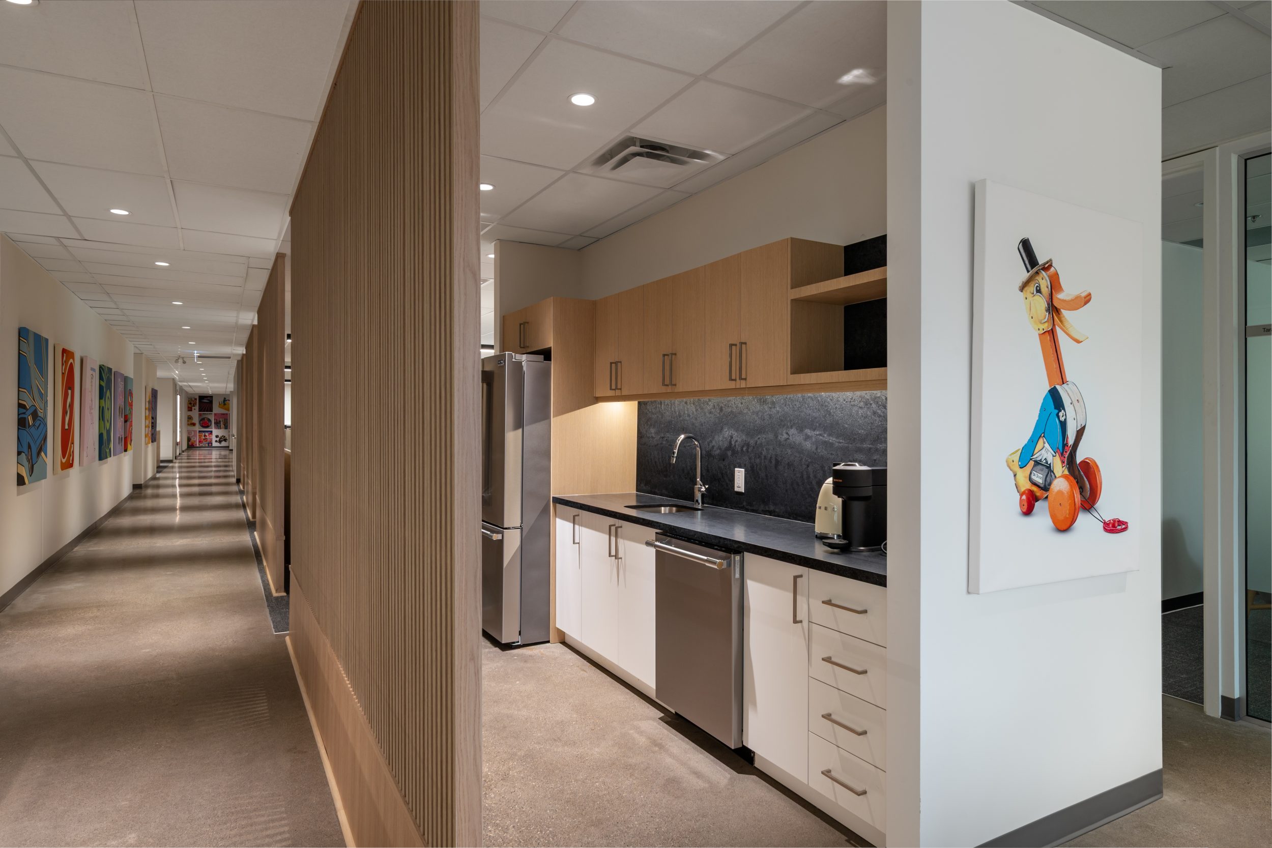 Modern executive office at Mattel Canada Headquarters in Mississauga, Ontario, showcasing custom millwork, collaborative meeting space, executive workstation, integrated technology, natural lighting, ergonomic furniture, premium interior finishes, workplace modernization, commercial office construction, and Design-Build project delivery by GTA General Contractors.