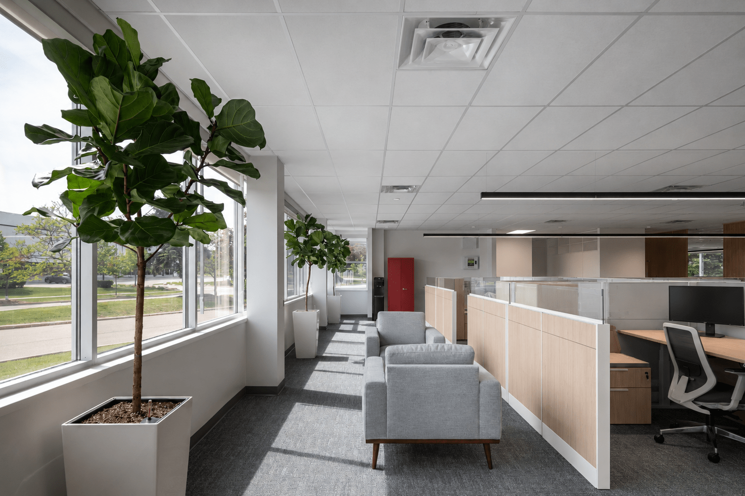 Open-concept corporate office workspace at Mattel Canada Headquarters featuring custom workstations, collaborative seating, abundant natural light, architectural lighting, modern office furniture, and premium commercial interior finishes completed through a Design-Build office renovation in Mississauga, Ontario.