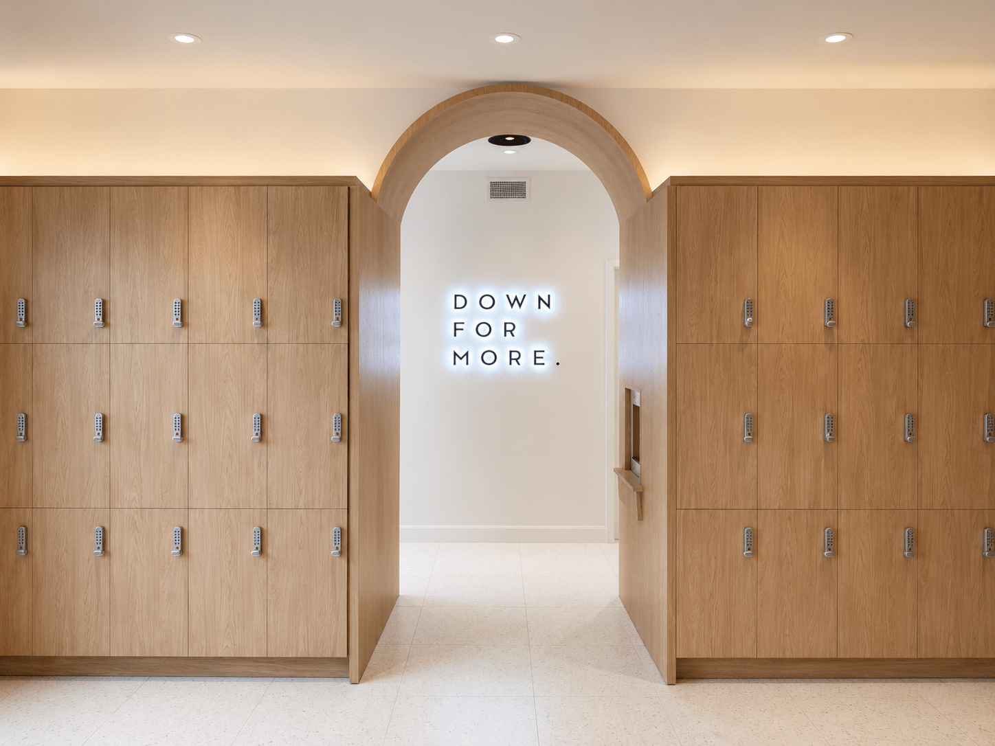 Custom architectural millwork lockers installed in a luxury fitness studio featuring premium wood cabinetry, integrated storage, commercial locker systems, wellness centre construction, and high-end interior finishes by GTA General Contractors.