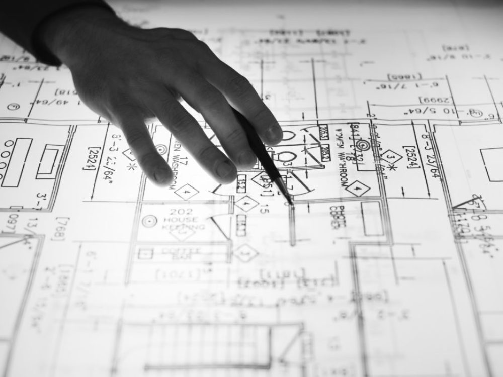 toronto commercial contractor advising a client on changes to architectural plans