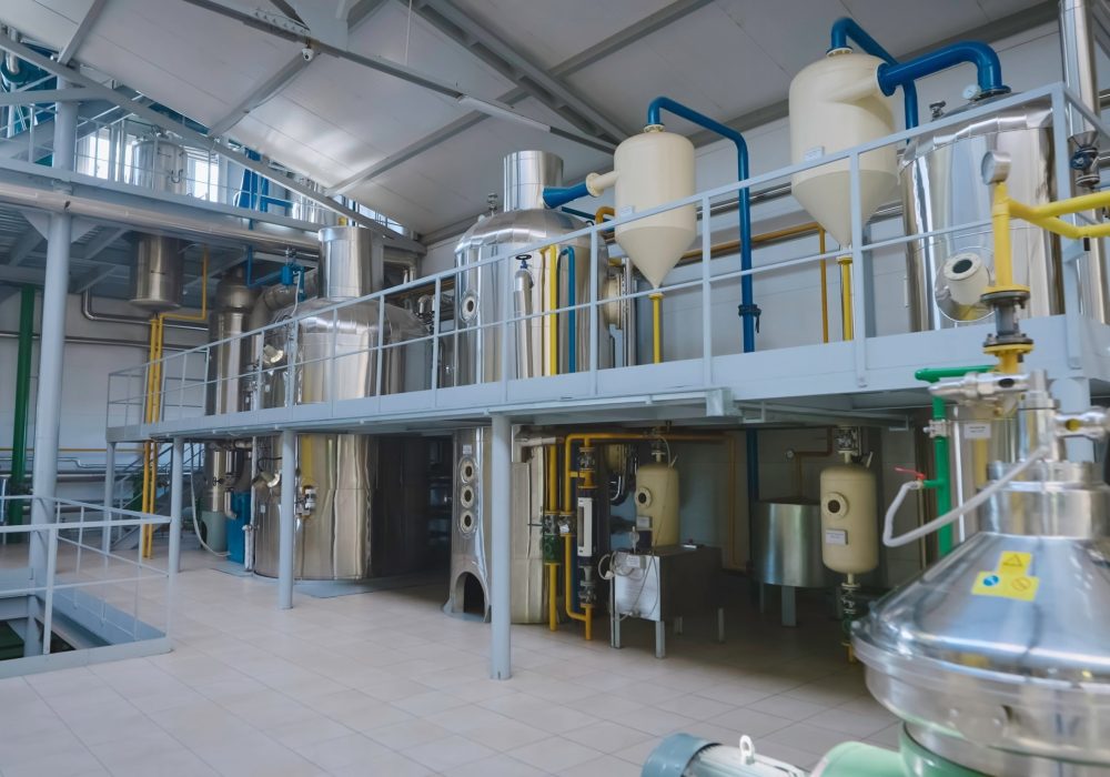 Ontario Food & Beverage Plant Construction | Industrial Processing Facility Modern food and beverage processing plant with stainless steel tanks, pipelines, and industrial equipment – Ontario commercial and industrial construction.