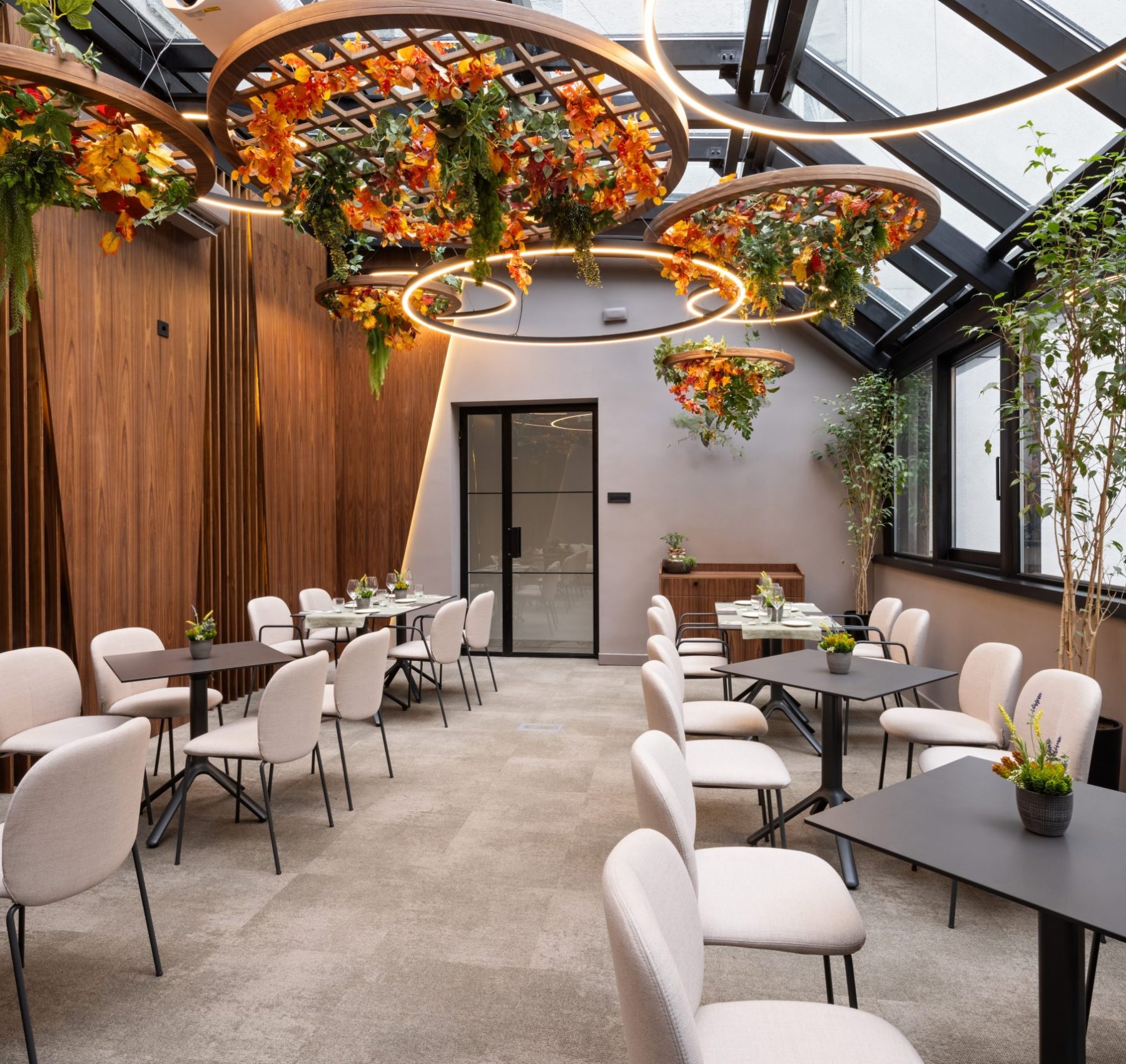 Restaurant Design & Construction Services in Toronto – GTA General Contractors Upscale restaurant dining space featuring natural wood finishes, greenery ceiling accents, and premium construction details
